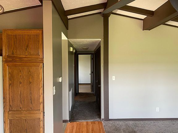 Standing in kitchen - hallway to bedrooms (2) and bathroom
