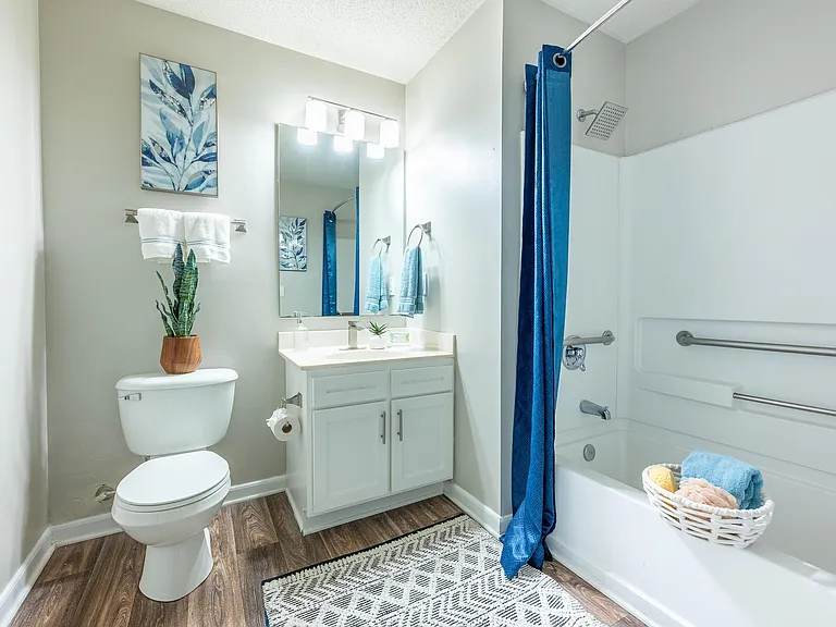 Bright bathroom with granite counters and bathtub