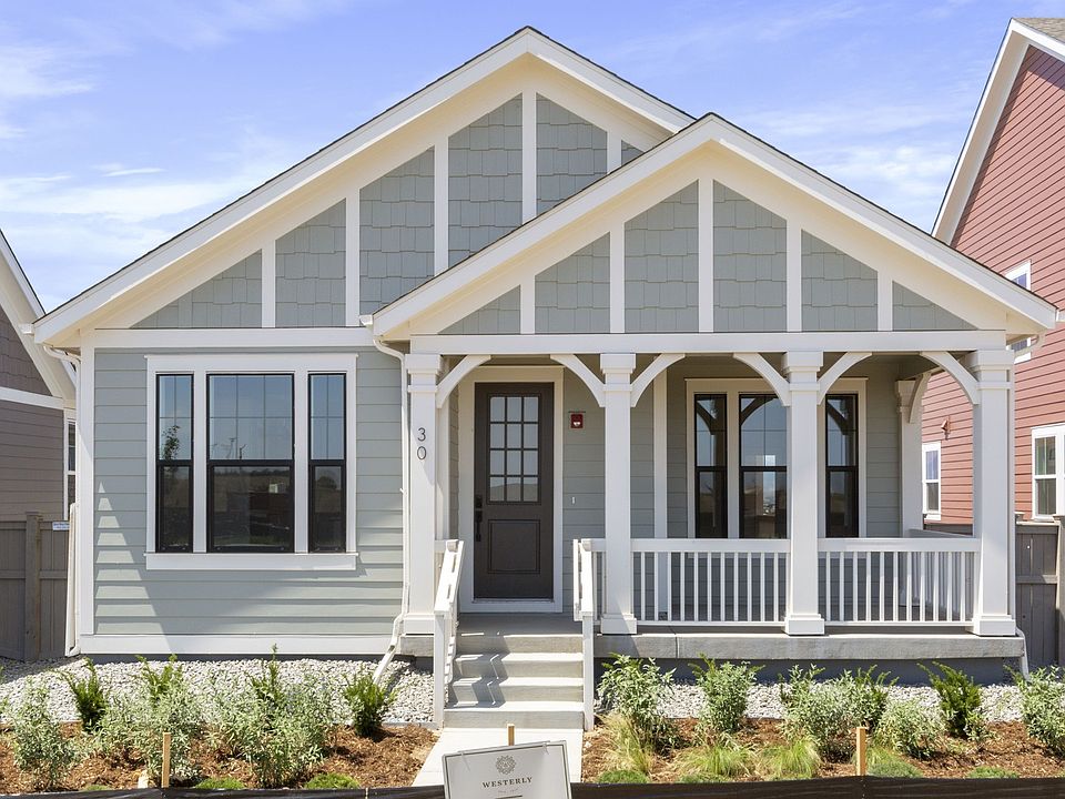 Elegant Craftsman home with refined white trim and vibrant red door. Located in the prestigious Carb