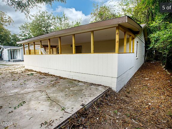 Well-maintained exterior featuring siding, large front windows for natural light, and a welcoming porch area.
