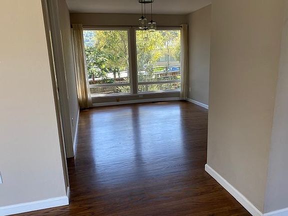 Living room looking into dining room with large picture window