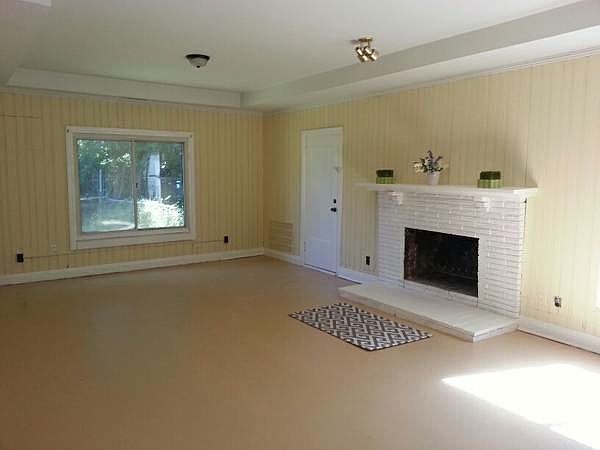 HUGE den with fireplace, walks out to patio.