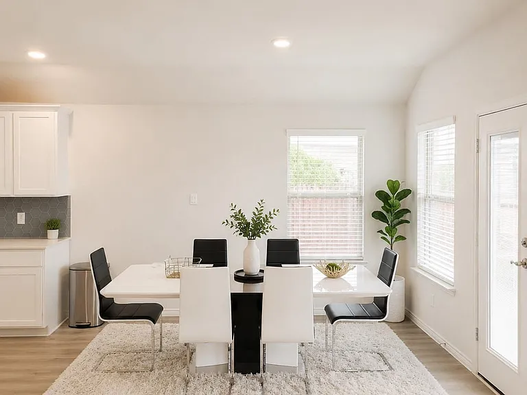 Open-concept dining area featuring light wood-finish flooring and recessed lighting