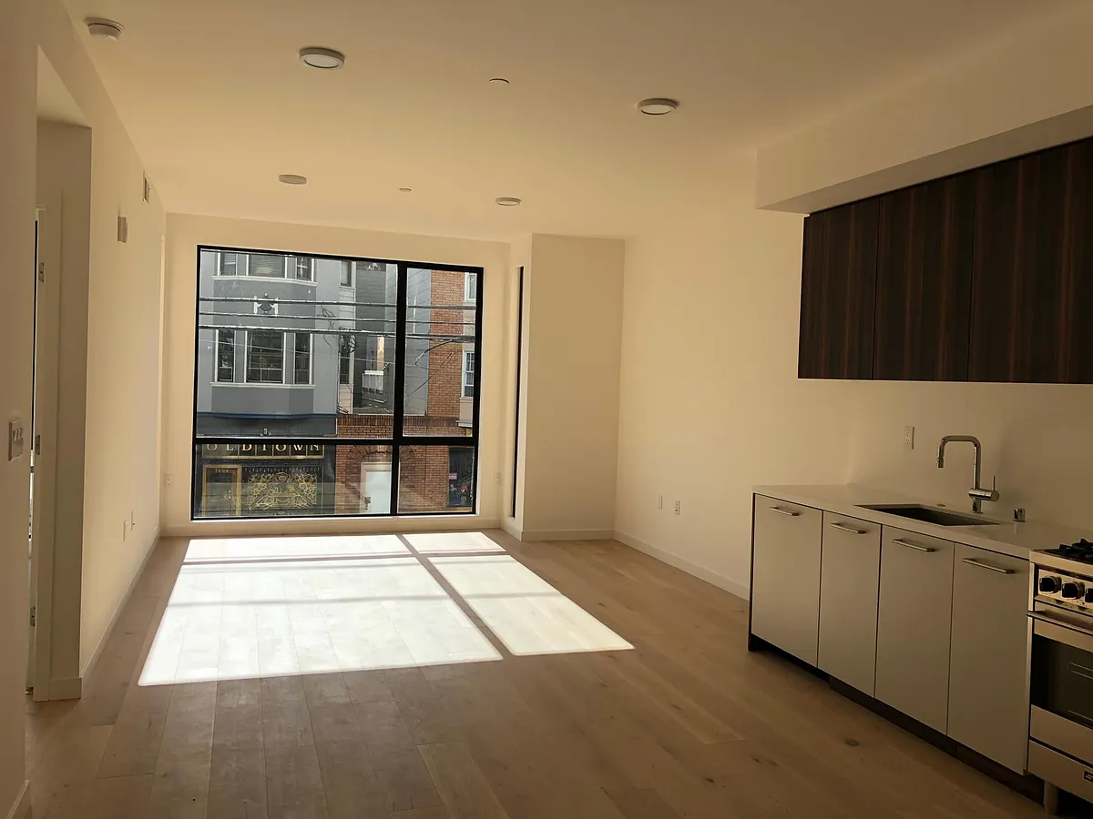 sunny south facing floor to ceiling window - without furniture - 1188 Valencia St #211