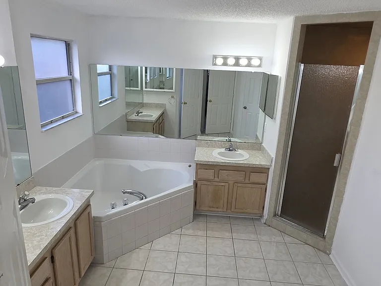 Master bathroom toilet closet, double separate sinks, Garden tub, and tiled shower with seat