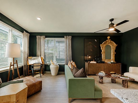 Stylish apartment living and dining area with oversized windows, designer finishes, and open-concept layout.