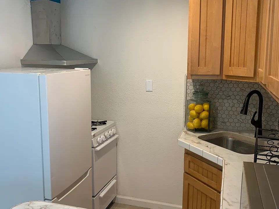 Cozy kitchen complete with gas stove, refrigerator, and microwave.