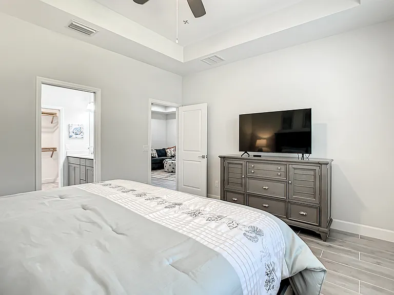 Primary bedroom with TV and ensuite bathroom