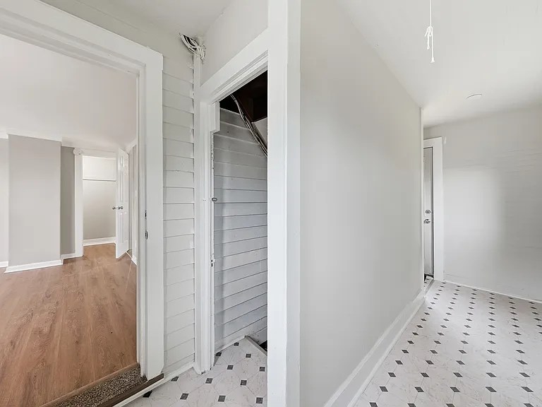 Back stairway with Access to Basement and Shared Laundry on Site