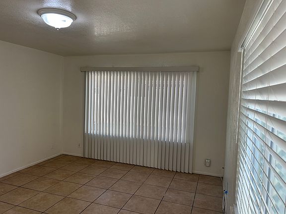 AT FRONT DOOR, LIVING ROOM WITH SHADE BLOCKING VERTICALS