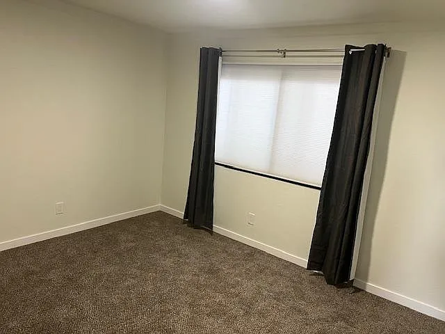 Good-sized bedroom with new carpets and curtains