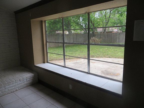 Large window looks out to backyard