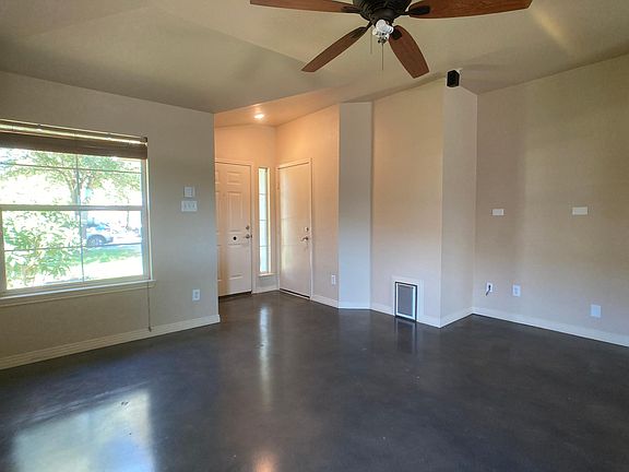 front entry, living area. Built-in cat door to space accessed in garage for litter box. Brown blinds will be replaced with white.