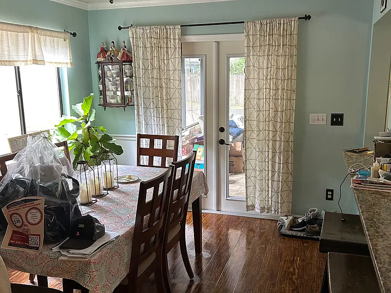 dining area off of the remodeled kitchen that leads to a large screened in porch