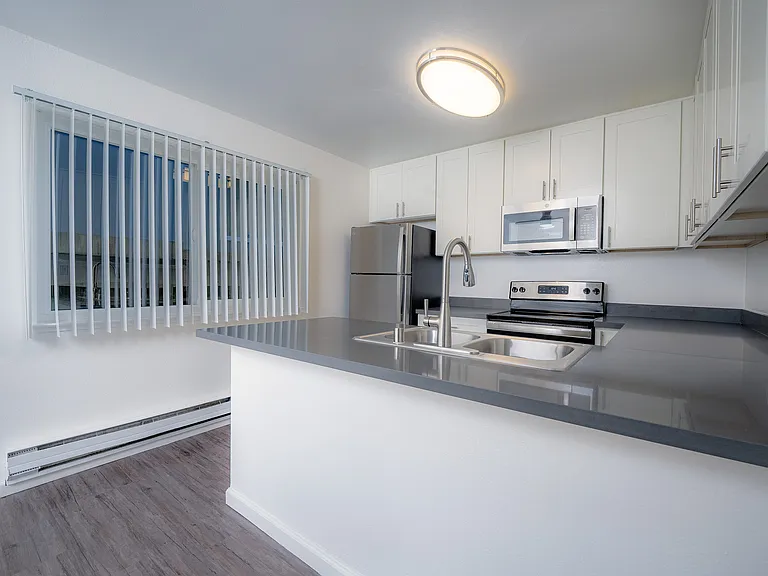 Experience modern convenience and style in this pristine kitchen space.