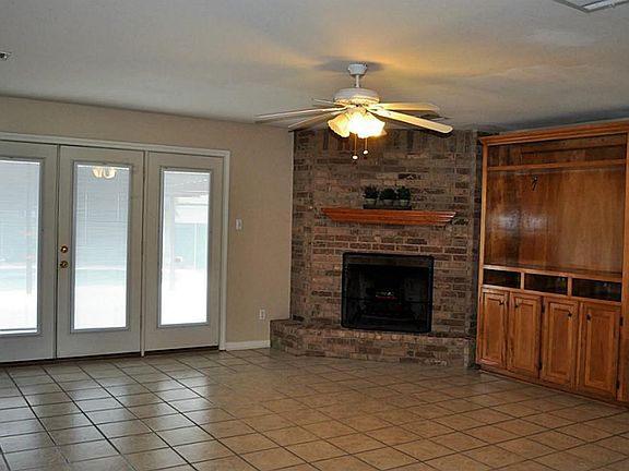 Huge Family Room w/Fantastic Views, Wood Built-Ins, Back Surround Sound Speakers, Cozy Fireplace & Double Doors That Lead to Entertaining Backyard Patio & Tropical Pool