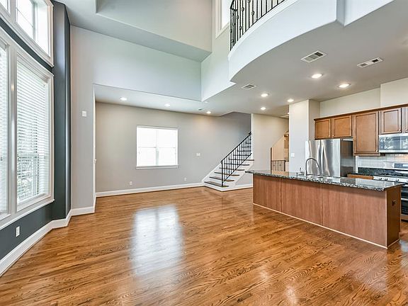 18x11 Living Room - Located on the second level and looking toward the dining area at the foot of the stairs and kitchen to the right. Note all the interesting changes in ceiling and wall planes and the balcony upstairs which is part of the primary b
