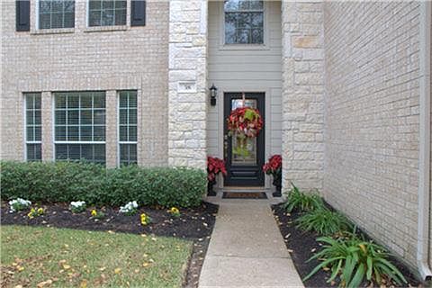 Notice the stone accents and fresh landscaping. Please come inside.
