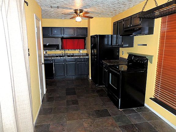 The kitchen features slate floors and countertops. There is new stove/range and refrigerator