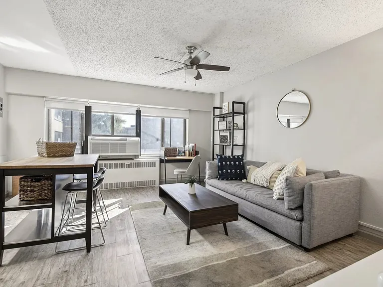 Cozy living room with a ceiling fan at Archer Tower in Denver, CO