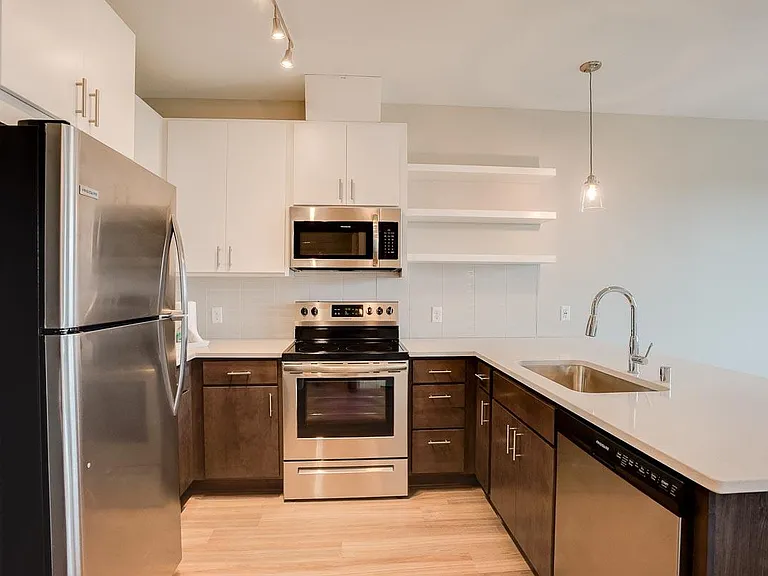 Cook and connect in our modern kitchens with granite countertops and sleek cabinetry.