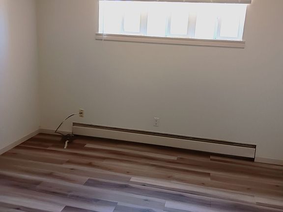 Bedroom with a ceiling fan and vigas.