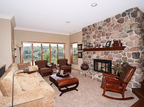 Open great room with walls of glass, remarkable vistas of lake.