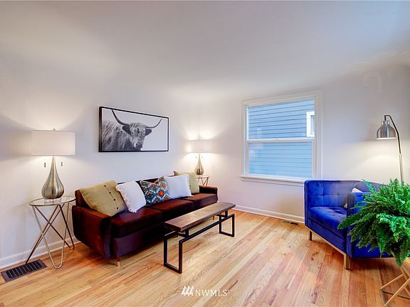 Original coved ceiling, arched doorway and wood floors in the living room.