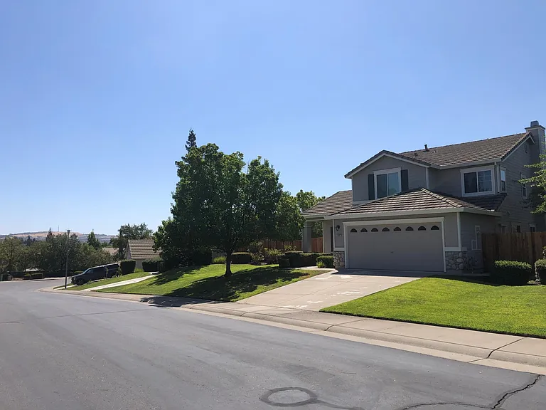 Front street view with cul de sac and scenic hillside view