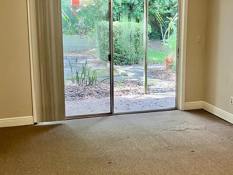 Master bedroom with patio facing landscaped backyard