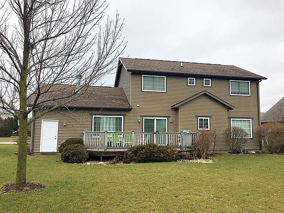 Back of home with deck and grill