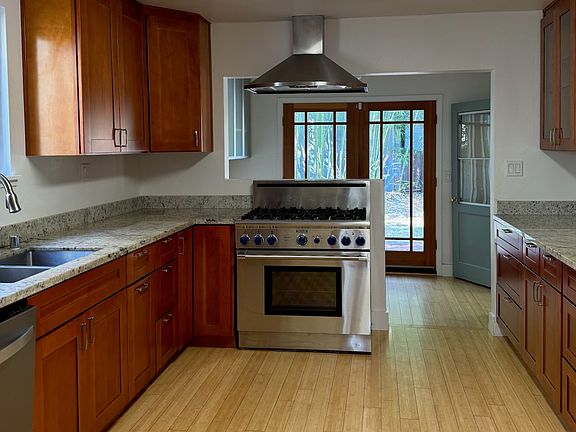 Upgraded Kitchen with new cabinets, a Wolf Range, marble counters a French Door leading to the back yard.