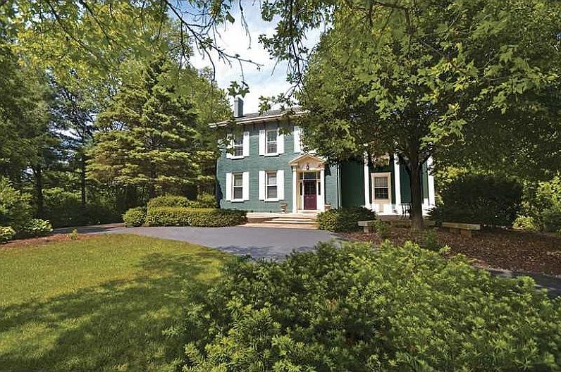 Exterior Front. Lush landscaping throughout the almost 3 acres.