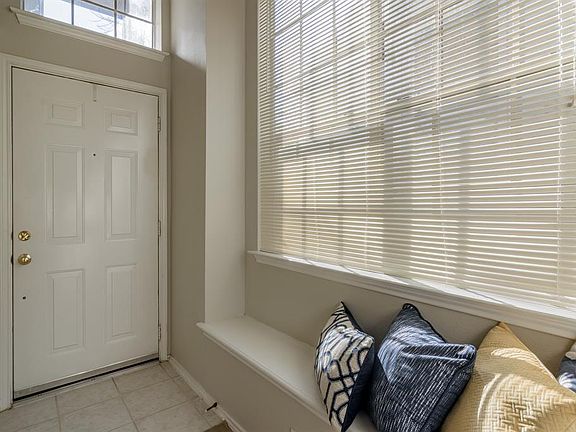 Foyer includes window seat and large windows.