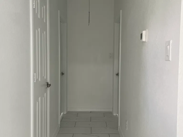 Hallway connects 2 bedrooms and 1/2 bathroom