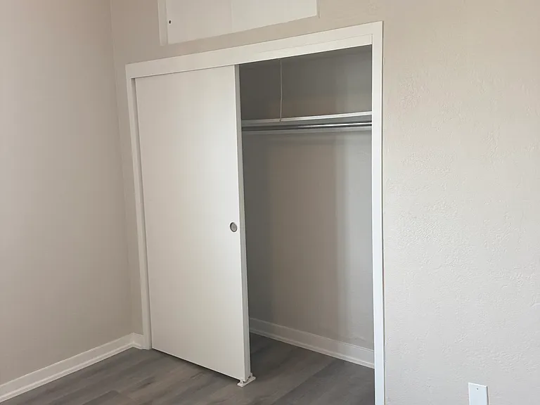 Bedroom Closet with storage above.