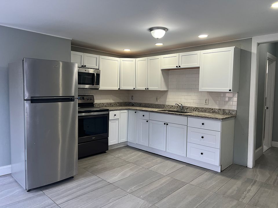 Modern kitchen with refrigerator, stove, and microwave