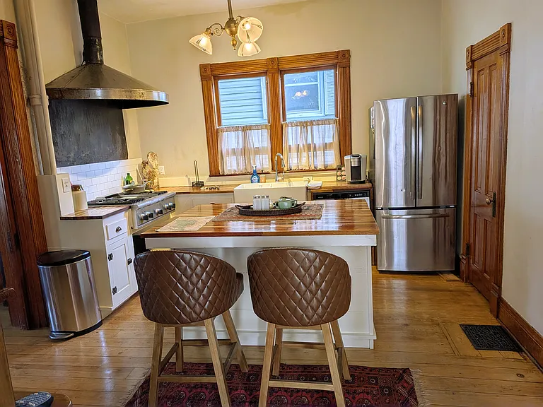 Kitchen located between Living Room and Dining Room. Thermador cooktop & oven. Large pantry (on right)