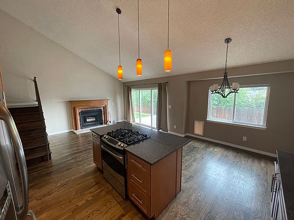 Kitchen island, family room , wood burning fireplace and dining