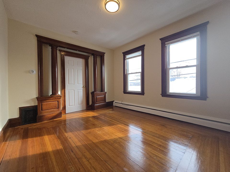 Living room with natural sunlight and hardwood floor and built in cabinet
