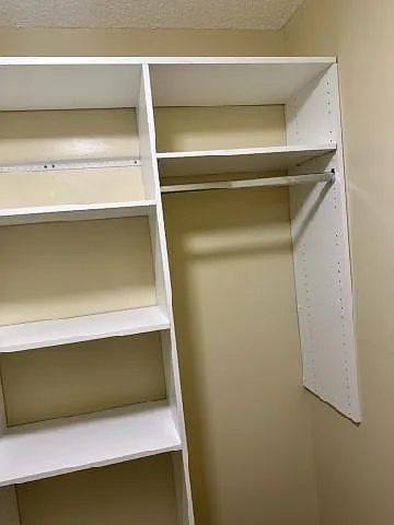 Bedroom closet has shelves for shoes or sweats, hats or t-shirts and store above top shelf of closet.