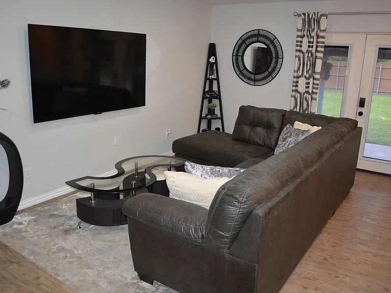 Unwind in a spacious, open-concept living room featuring plenty of comfortable seating meaning there is room for everyone to relax and make lasting memories together.