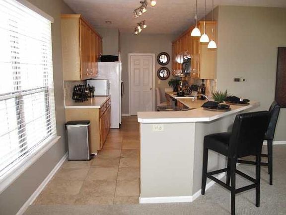 Kitchen offers custom Flooring, Backsplash, ample Cabinets & CounterTop space.