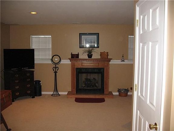 Lower level recreation room with fireplace