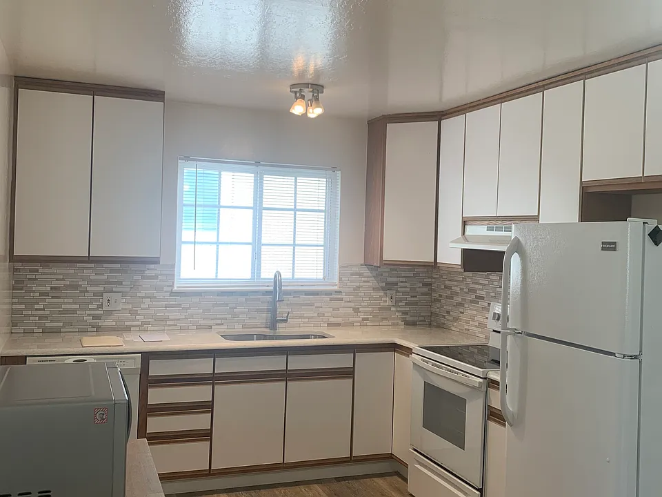 Kitchen, quartz countertops, dishwasher, garbage disposal, electric range and refrigerator.