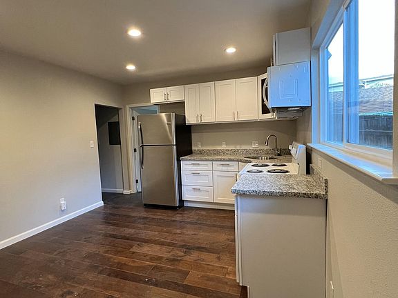 kitchen with access to larger bedroom and hall to bath