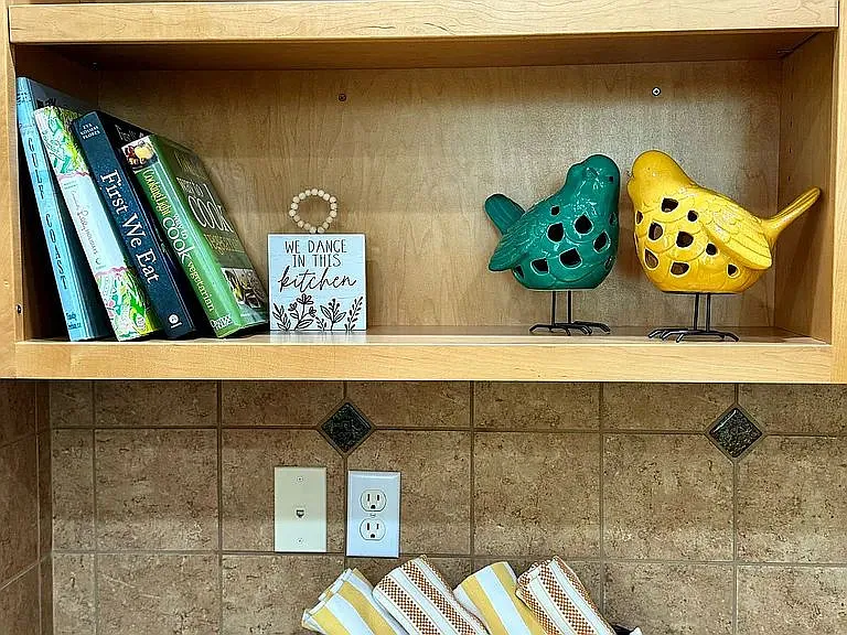 Open shelving in kitchen can be used as office area or for additional decor