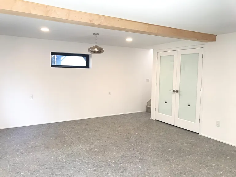 Downstairs master bedroom with large walk-in closet & washer dryer. French doors lead out to downstairs outdoor patio & garden.