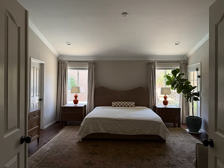 Primary bedroom featuring vaulted ceilings and a relaxing atmosphere.