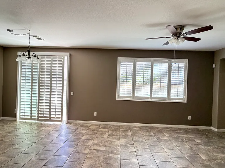 Living and dining room with plantation covers
